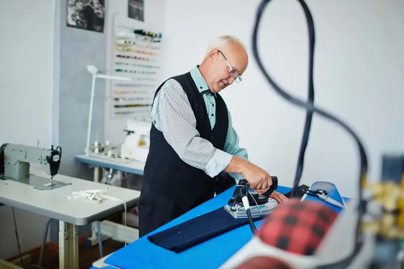 Professional pressing company uniforms on an ironing table Herefordshire